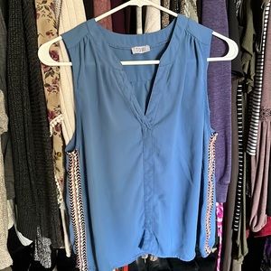 Light blue sleeveless blouse with side details